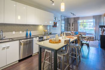 Kitchens with quartz countertops, islands, and energy efficient, stainless steel appliances